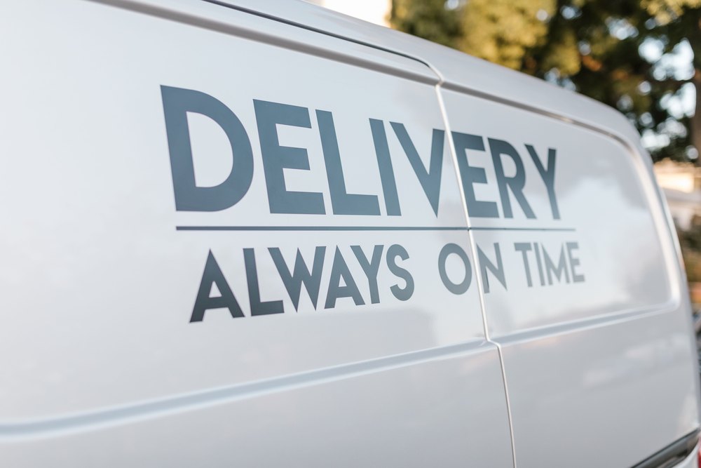 Close-up of cut vinyl lettering running across a van flank