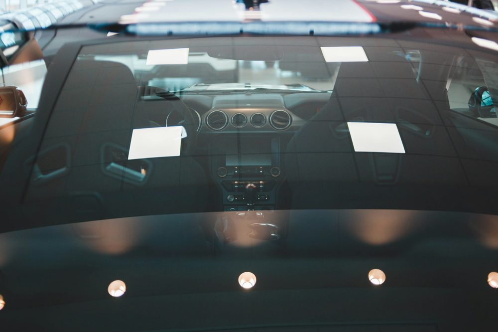A resin injector bridged over a stone chip in a windscreen